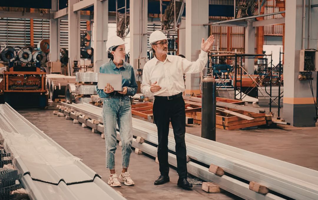Business leaders reviewing operations on a manufacturing floor