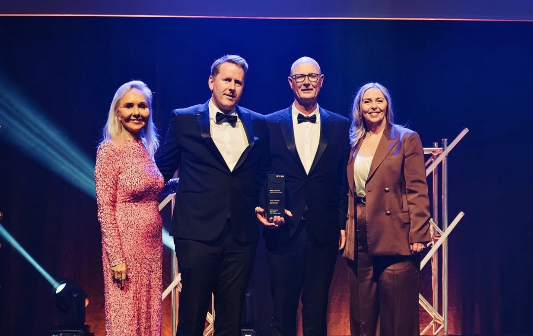Daren Leng and Ben Smith on stage receiving the REINZ Business Broking Deal of the Year award, 2026 REINZ Awards for Excellence