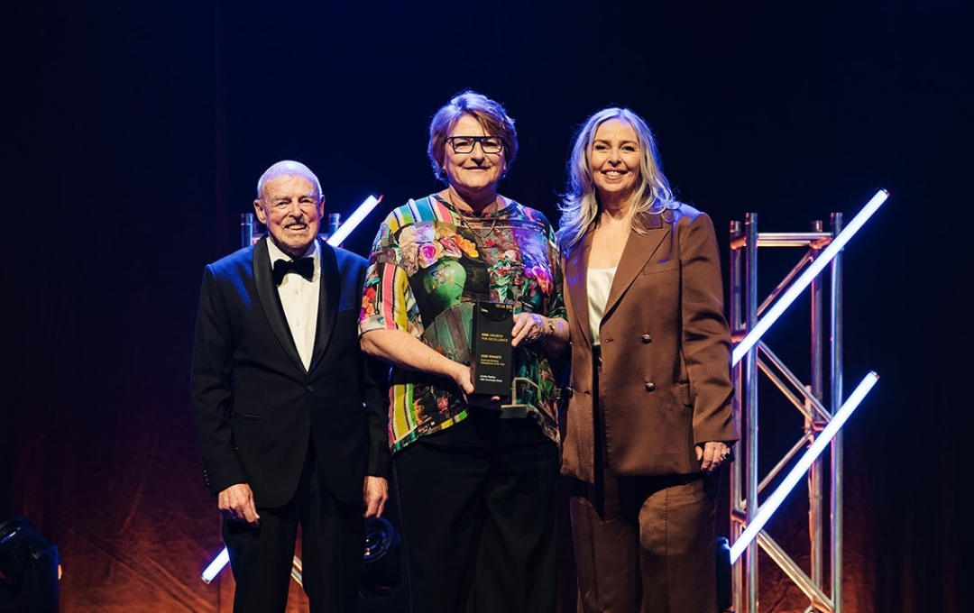 Linda Harley on stage with her REINZ Business Broking Salesperson of the Year award, 2026 REINZ Awards for Excellence